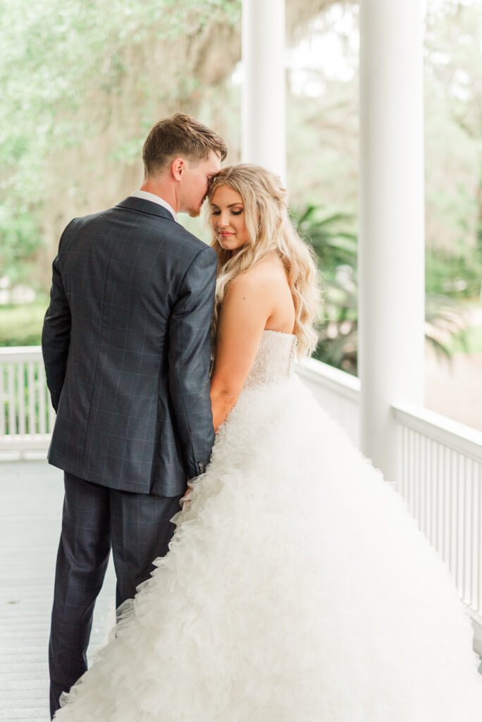 bride and groom portraits on the porch of goodwood museum and garden