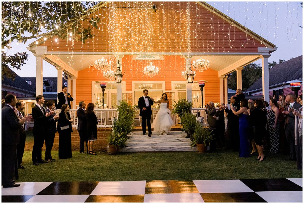 Newlyweds enter their reception down a marble staircase of the porch of the main building at south eden plantation