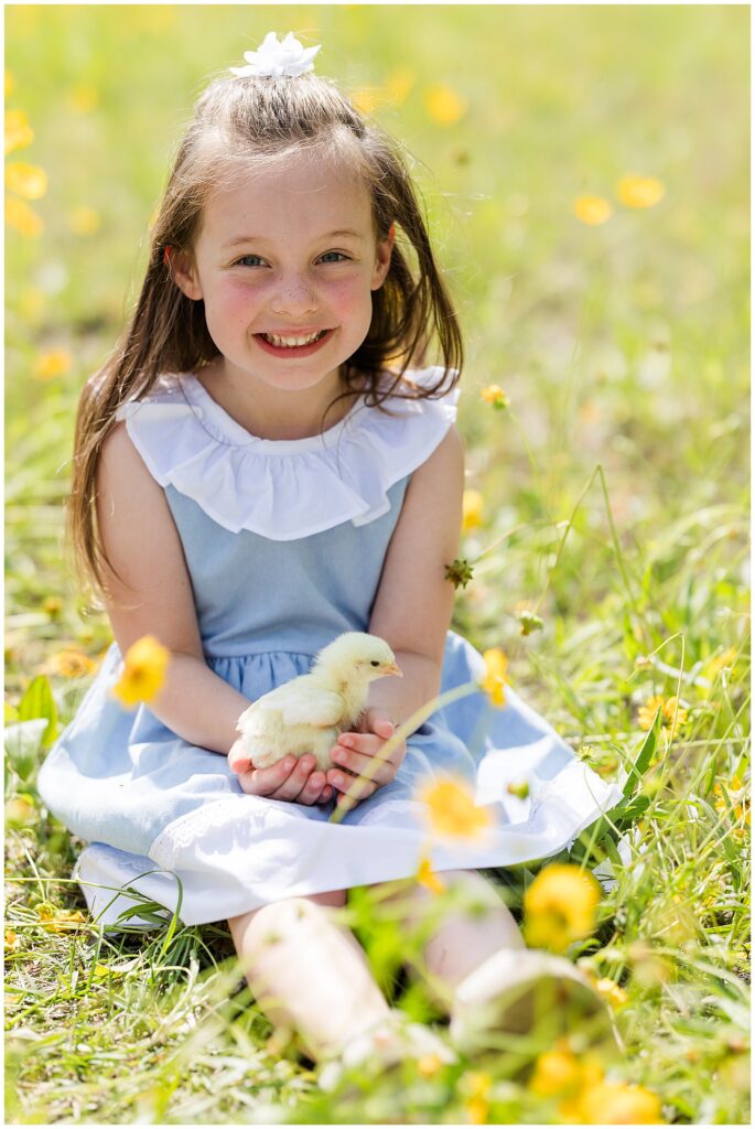little girl with a baby chicken