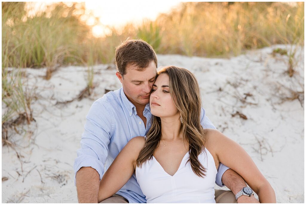 Matt and Taylor walking hand-in-hand along the shoreline during their engagement session at Mashes Sands Beach near Tallahassee, FL