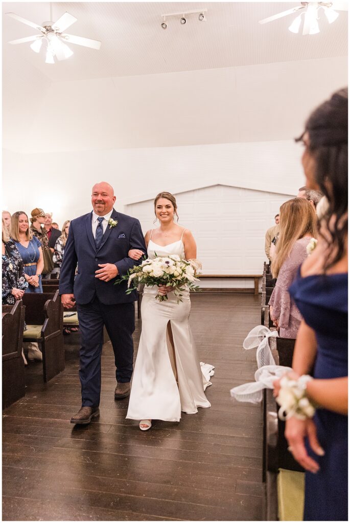 Bride walking down the aisle with her father during outdoor ceremony at Shiloh Farm wedding in Tallahassee