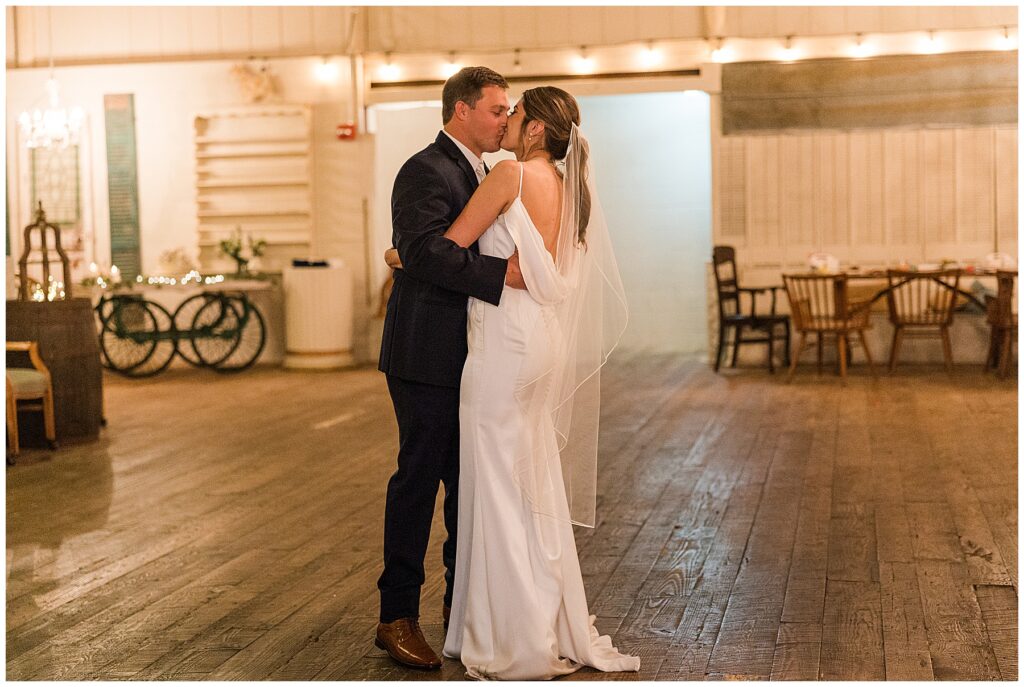 Bride and groom share first dance under string lights at barn wedding reception at Shiloh Farm in Tallahassee