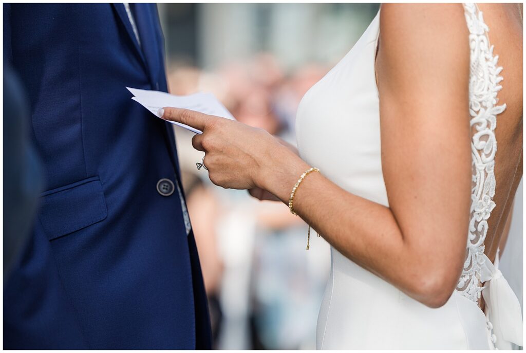 Coastal wedding ceremony arch with greenery and flowers