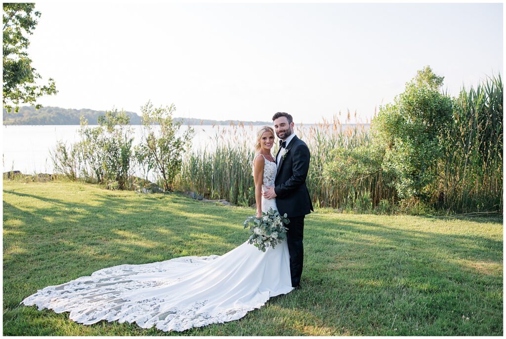 Bride and groom standing forehead to forehead with palm trees in the background during North Florida coastal wedding