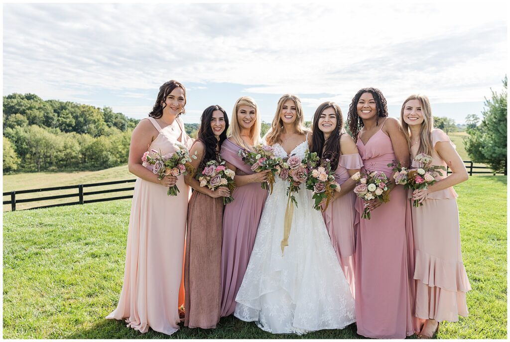 bride and bridesmaids taking portraits before the ceremony in north florida