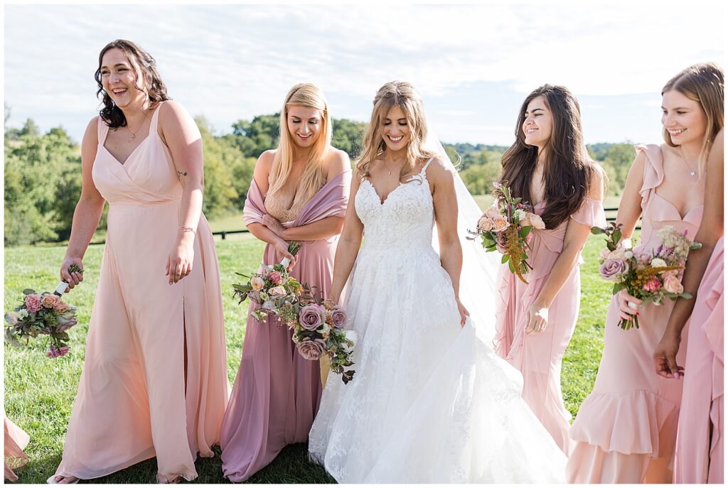 bride and bridesmaids laughing together after ceremony