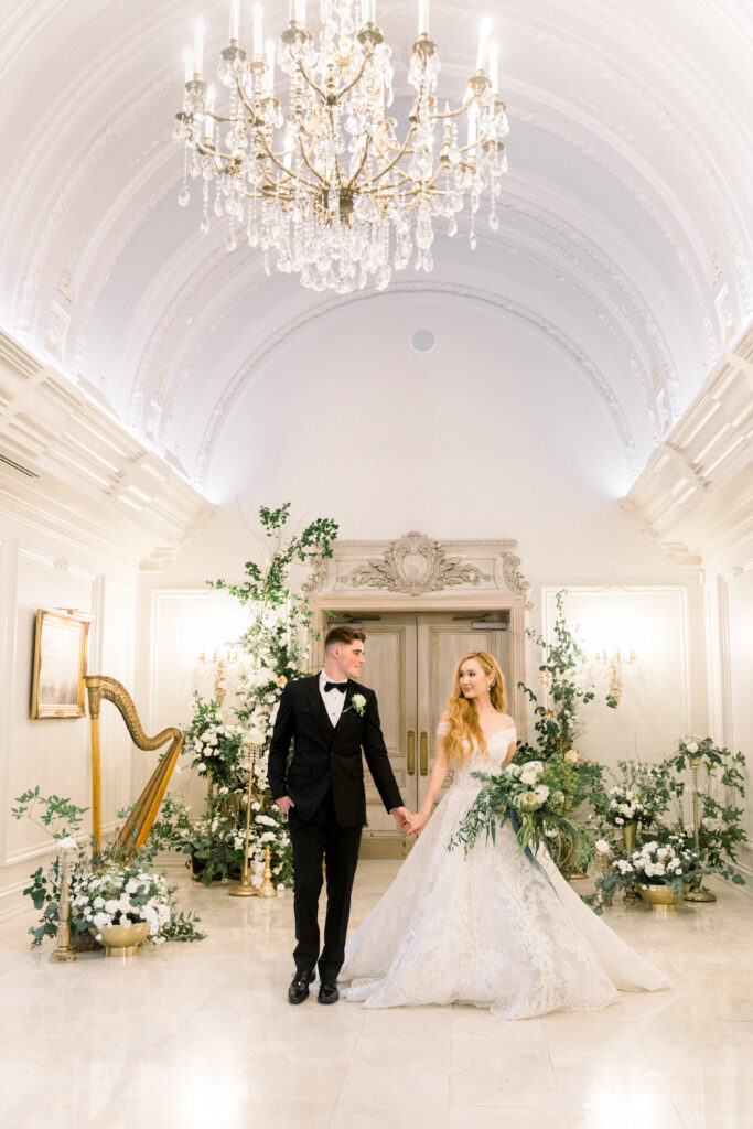 Bride and groom holding hands at their ceremony space